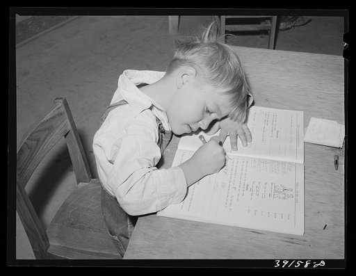Schoolgirl at the FSA (Farm Security Administration) farm workers' camp. Caldwell, Idaho. Several family units of the row shelters have been thrown open to form a big room for the school