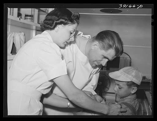 Doctor and nurse at the FSA (Farm Security Administration) migratory labor camp mobile unit. Wilder, Idaho. Doctor visits the trailer-clinic twice a week