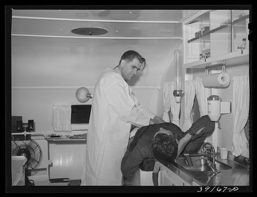 Untitled photo, possibly related to: Examination in trailer-clinic at the FSA (Farm Security Administration) migratory labor camp mobile unit. Wilder, Idaho
