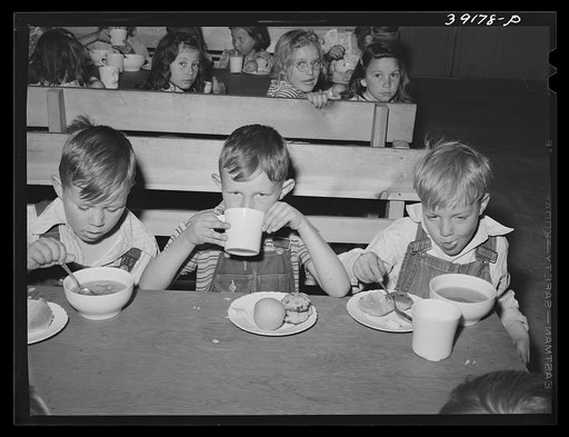 Schoolchildren having lunch at the FSA (Farm Security Administration) farm workers' camp. Caldwell, Idaho