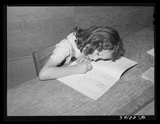 Untitled photo, possibly related to: Schoolgirl at the FSA (Farm Security Administration) farm workers' camp. Caldwell, Idaho. Several family units of the row shelters have been thrown open to form a big room for the school