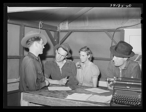 Camp manager (left) talking to newly-arrived farm workers at the FSA (Farm Security Administration) migratory labor camp. Wilder, Idaho