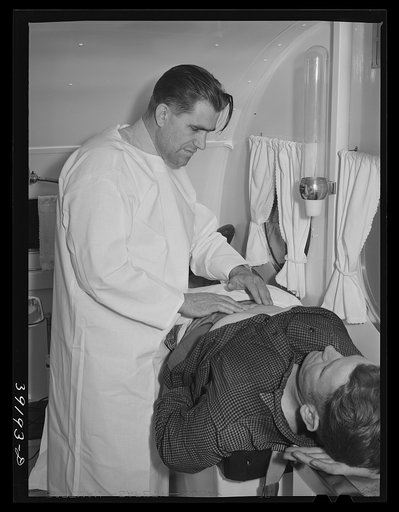 Examination in trailer-clinic at the FSA (Farm Security Administration) migratory labor camp mobile unit. Wilder, Idaho