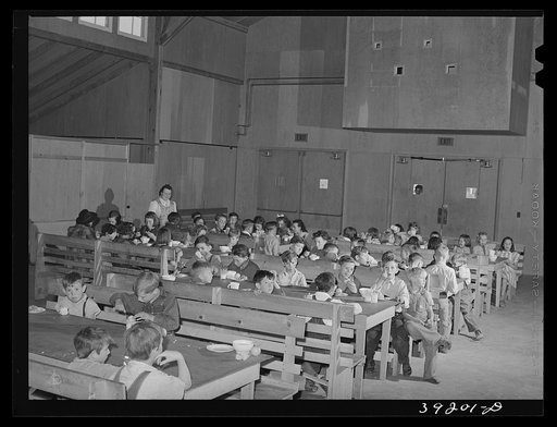 Lunchtime for schoolchildren at the community building of the FSA (Farm Security Administration) camp for farm workers. Caldwell, Idaho