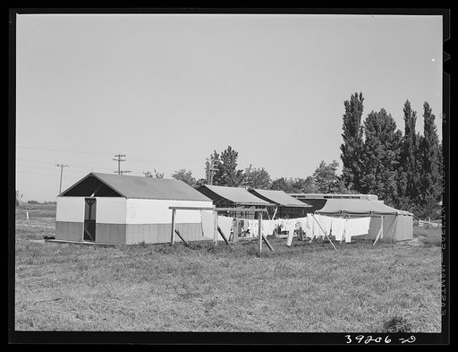 Overall view of laundry, shower and power units at the FSA (Farm Security Administration) migratory labor camp mobile unit. Wilder, Idaho