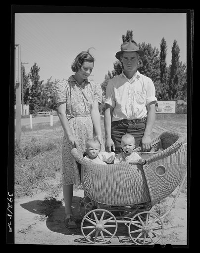 Farm worker with his wife and their twin babies at the FSA (Farm Security Administration) migratory labor camp mobile unit. Wilder, Idaho