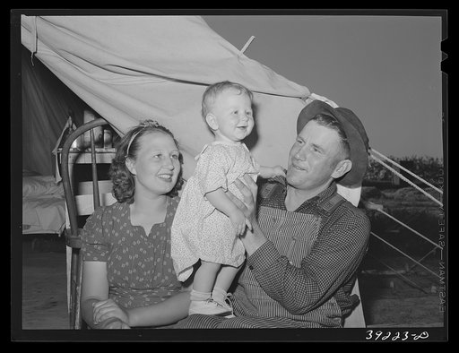 Farm worker, his wife and child at the FSA (Farm Security Administration) migratory labor camp mobile unit. Wilder, Idaho