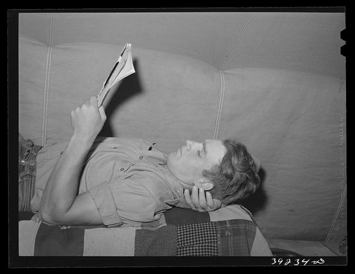 Young farm worker in tent at the FSA (Farm Security Administration) migratory labor camp mobile unit. Wilder, Idaho