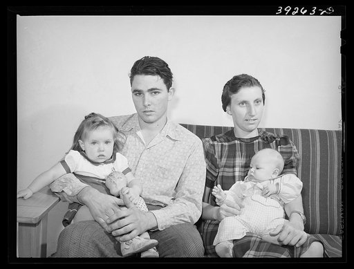 Family group of family living in house at Kearney Mesa defense housing project. This man came out to California from Oklahoma ten years ago. He has been an agricultural worker and has lived in various FSA (Farm Security Administration camps). He is now employed as a painter at the Consolidated Aircr