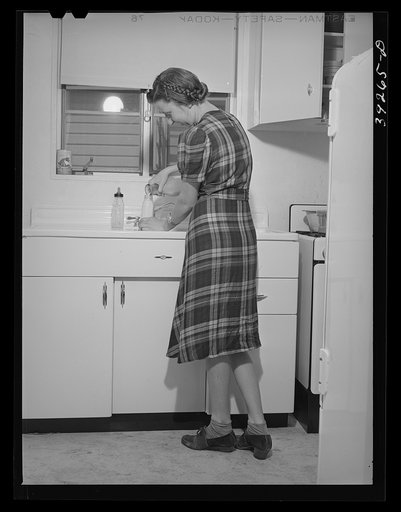Mother preparing baby's bottle. She lives in one of the houses at the Kearney-Mesa defense housing project