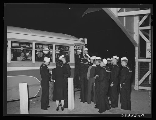 Sailors boarding a bus at Mission Beach, amusement center. San Diego, California