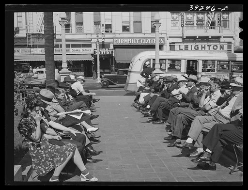 Untitled photo, possibly related to: Sailors lined up against chain-rail in square in midtown. San Diego, California