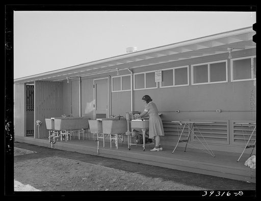 Tenant at the FSA (Farm Security Administration) camp for defense workers doing her laundry. San Diego, California