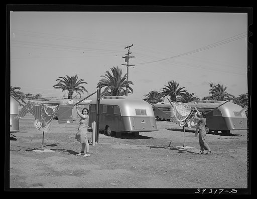 Tenant at the FSA (Farm Security Administration) trailer camp for defense workers hanging up her washing. San Diego, California