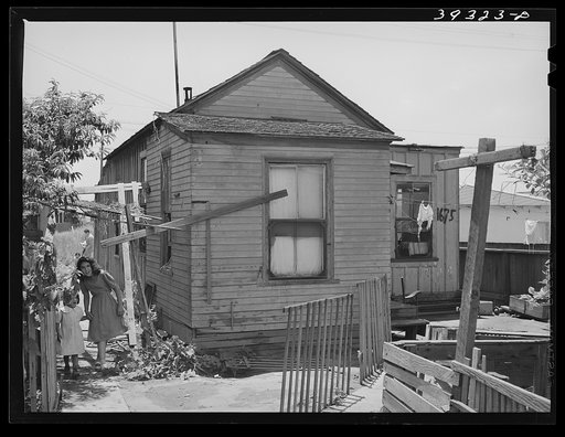 Little Mexican girls coming up alley walk which leads to their home. San Diego, California