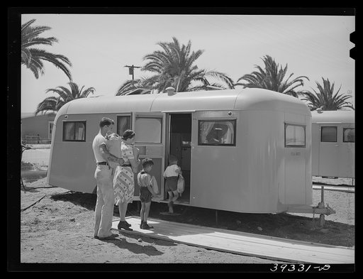 Family moving into trailer at the FSA (Farm Security Administration) camp for defense workers. This family is from Minnesota. The man came to San Diego ten months ago and enrolled in a vocational school. He started to work at Consolidated Aircrafts as a riveter and is now a clerk in the machine shop