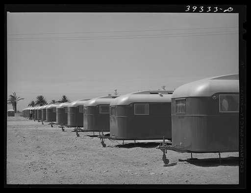 Line-up of trailers at the FSA (Farm Security Administration) camp for defense workers. All trailers rent for seven dollars per week--rental fee includes electricity and water and use of laundry and all sanitary facilities. There is a fee of ten cents for twenty minutes usage of electrical washing m