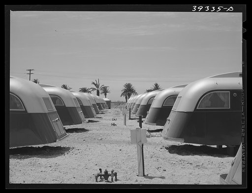Line-up of trailers at the FSA (Farm Security Administration) camp for defense workers. All the posts seen in the center are for electrical connections. San Diego, California