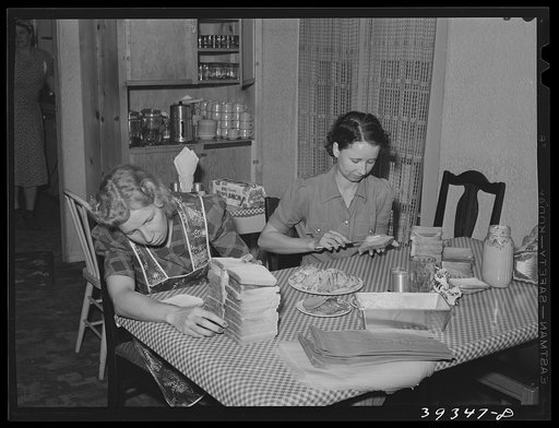 Maids making sandwiches for night shift workmen at Consolidated Aircrafts. This is in a boarding house for single men. They are given room and board--two meals every day and a lunch consisting of three sandwiches, fruit and cake for eight dollars weekly. While this house is clean and liked by the bo
