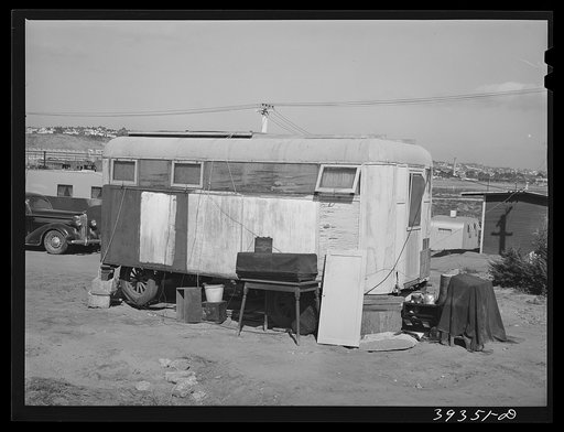 Trailer in trailer court. This trailer is obviously unmovable and because this court is assuming the characteristics of a shack town and because the sanitary facilities are inadequate, it will probably be condemned by board of health. San Diego, California