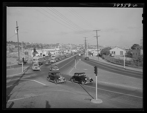 Untitled photo, possibly related to: Traffic moving out of town on main highway when Consolidated Aircrafts changes shift in the afternoon. San Diego, California
