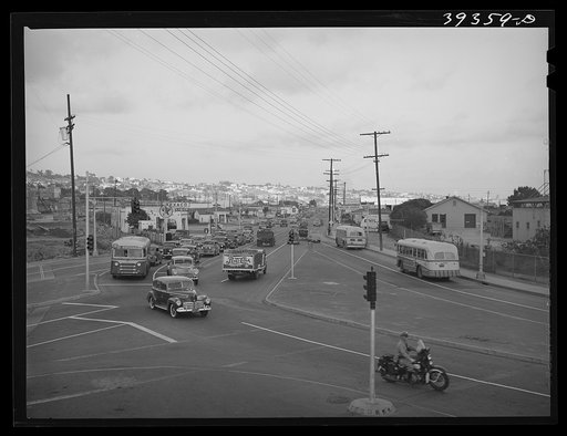 Traffic moving out of town on main highway when Consolidated Aircrafts changes shift in the afternoon. San Diego, California