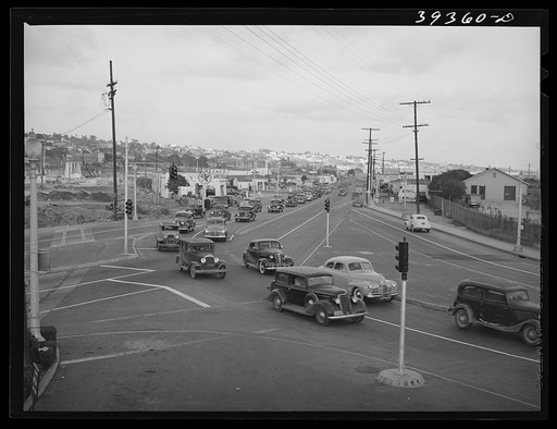 Untitled photo, possibly related to: Traffic moving out of town on main highway when Consolidated Aircrafts changes shift in the afternoon. San Diego, California