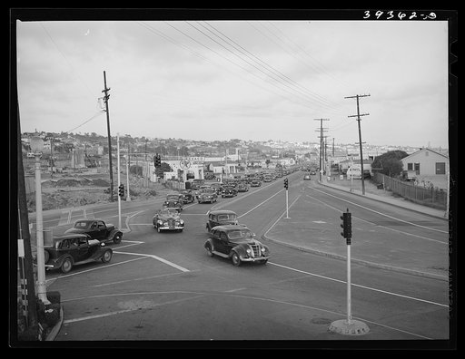 Traffic moving out of town on main highway when Consolidated Aircrafts changes shift in the afternoon. San Diego, California