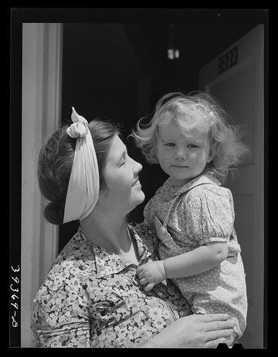 Mother and child who live in one of the family units of the Navy defense housing project for Marine and Navy enlisted men. San Diego, California