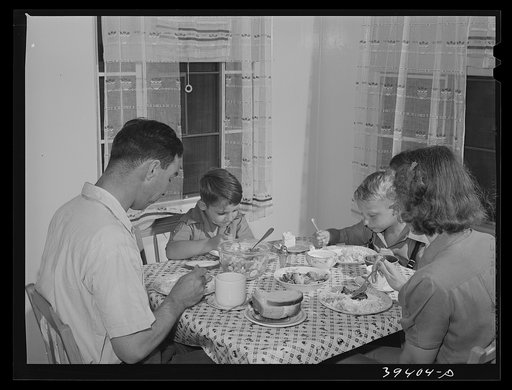 Marine sergeant and his family in the dining room of his home at the Navy defense housing for Navy and Mareines and some defense workers. San Diego, California