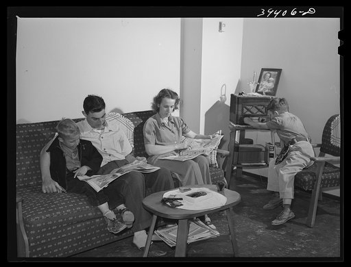 Family of Marine in their living room. They live in one of the units of the Navy defense housing project which is designed for Naval people, Marines and some civilian defense workers. San Diego, California