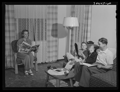 Family of Marine in their living room. They live in one of the units of the Navy defense housing project which is designed for Naval people, Marines and some civilian defense workers. San Diego, California