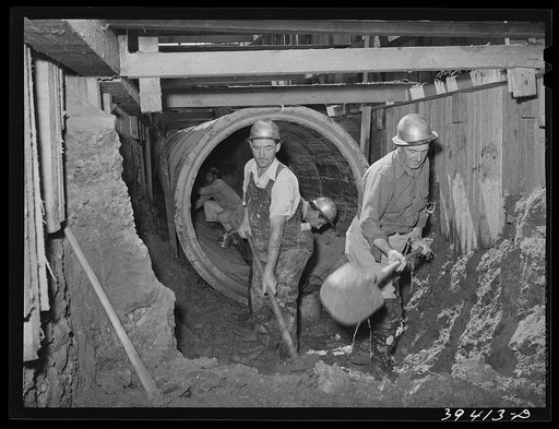 Excavating work, construction of sewage lines and sewage disposal plant, a WPA (Work Projects Administration) national defense project sponsored by the city of San Diego. All excavating on this project up to date has been done by hand--but big equipment is now being moved in. San Diego, California