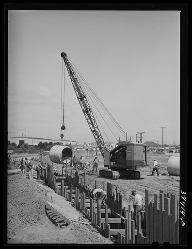 Laying sewer tile leading to the sewage disposal plant now under construction. There are two miles of this large-size tile. San Diego, California