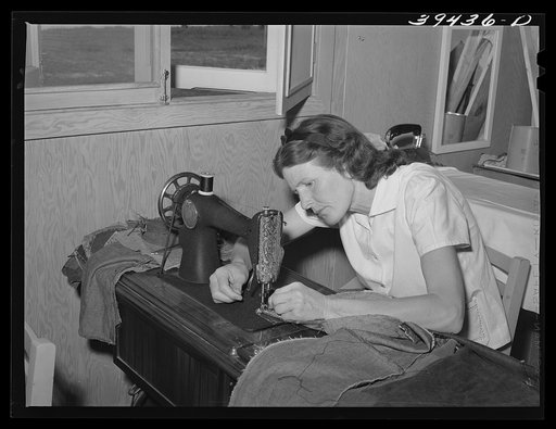 In the sewing class which is a WPA (Work Projects Administration) project at the FSA (Farm Security Administration) labor camp. The women are shown how to make overgarments