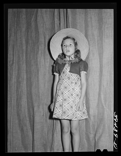 Daughter of migratory farm worker in program at the end of school term. FSA (Farm Security Administration) labor camp. Caldwell, Idaho