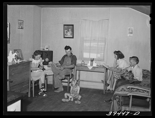 Farm worker and his family in their cottage at the FSA (Farm Security Administration) labor camp. Caldwell, Idaho. He is one of the "permanent" farm workers