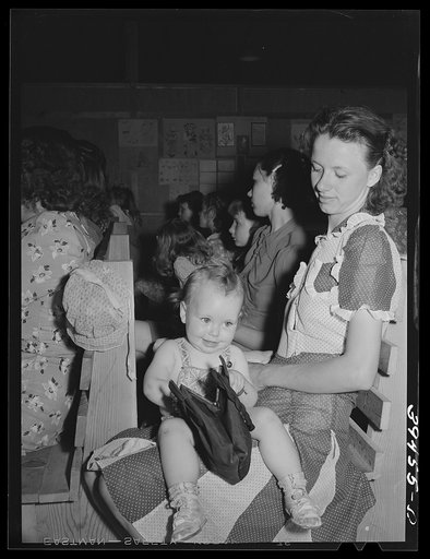 FSA (Farm Security Administration) labor camp. Farm worker's wife and young daughter at the school program at the end of the term
