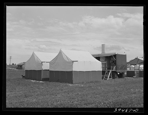 Nampa, Idaho. Mobile unit of the FSA (Farm Security Administration) camp for migratory farm workers. Tents of staff members and the power unit in the background