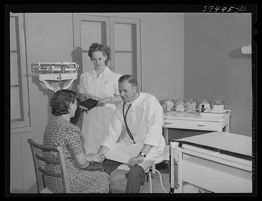 Doctor and nurse with patient at the clinic of the FSA (Farm Security Administration) and farm labor camp. Caldwell, Idaho