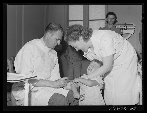 Doctor and nurse give daughter of farm worker tick fever serum at the FSA (Farm Security Administration) labor camp. Caldwell, Idaho