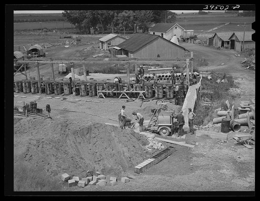 Making tiling to be used in irrigation. Canyon County, Idaho