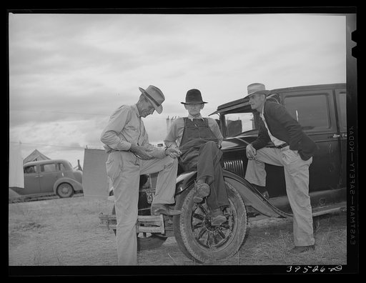 Untitled photo, possibly related to: Pea pickers talking in camp. Canyon County, Idaho. These pickers travel with the labor contractors. The contractor is responsible for getting the jobs for the pickers