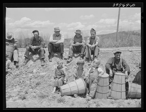 Pea pickers waiting to start work. Canyon County, Idaho. These pickers travel with a labor contractor. The children who are shown are not necessarily pickers. Since the camp was near by the field and it seemed to be customary for the children to follow along. However there were some nine-year-old ch