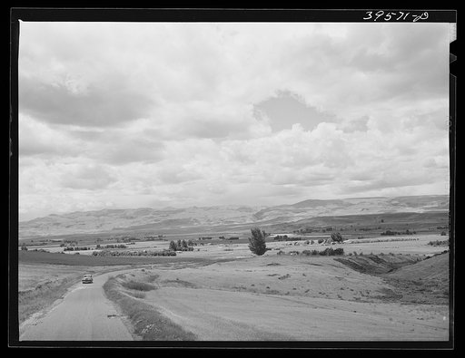 Irrigated farming land with mountains surrounding. Canyon County, Idaho. More than half of cultivated land in Idaho is under irrigation and this irrigated land is definitely on the increase