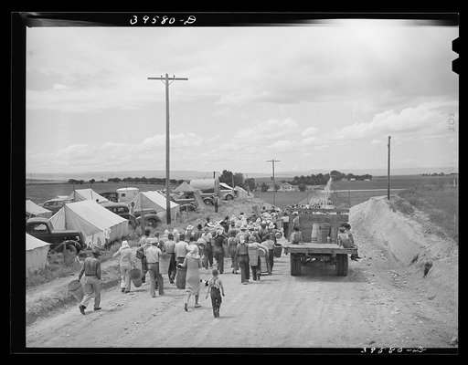 Pea pickers leaving labor contractor camp for field. Canyon County, Idaho