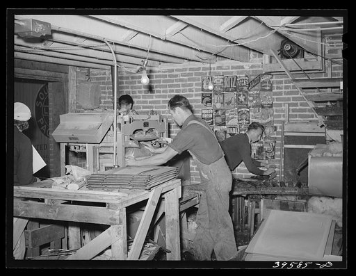 In the lettuce packing plant. Canyon County, Idaho. Notice various labels for lettuce on wall in background