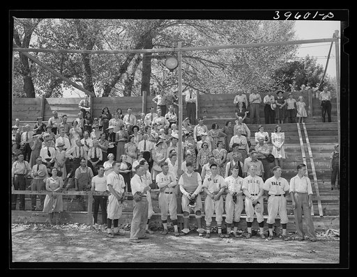 Baseball players and spectators stand at attention while Chief Justice Stone gives the oath of allegiance over the radio. Vale, Oregon