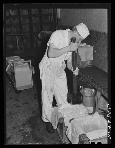 Packing butter into tubs at the Dairymen's Cooperative Creamery. Caldwell, Canyon County, Idaho. The dairymen's cooperative is a member of two regional cooperative marketing associations. Butter is marketed through the Challenge Cream and Butter Association
