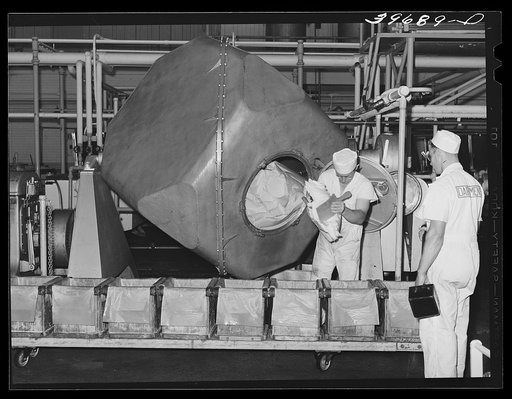 Taking butter out of churns at the Dairymen's Cooperative Creamery. Caldwell, Canyon County, Idaho. These are some of the most modern churns in the United States. All butter of this creamery is marketed through the Challenge Butter and Cream Association, a cooperative marketing association, and is s